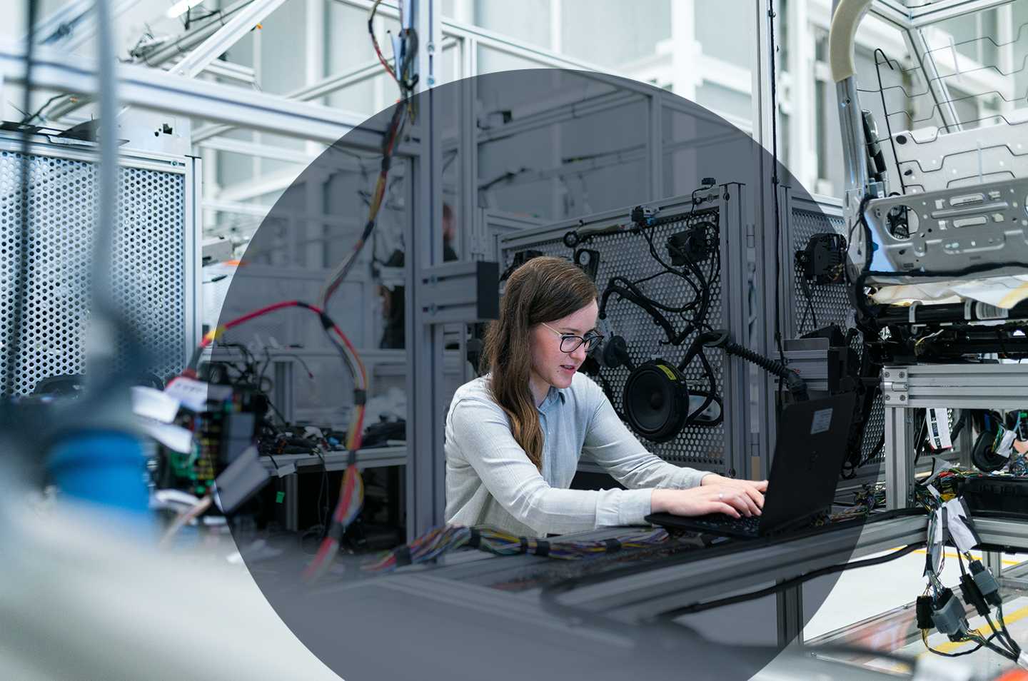 woman sitting in a workshop at a computer